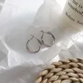 Elegant silver-toned twisted hoop earrings featuring a minimalist intertwined design - Twisted Twist Style (HE3757) / Silver