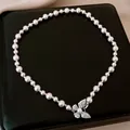 Elegant white pearl necklace featuring a sparkling crystal butterfly pendant design - Pearl Pave Rhinestone Butterfly Style / Silver Pink