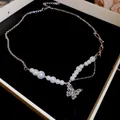 Elegant silver chain necklace featuring white pearls and a sparkling crystal butterfly pendant - Pearl Bowknot Transparent Butterfly Style / Silver