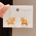 Close-up of gold-plated unicorn stud earrings with orange inlay on 316L steel card. - Gold Orange Unicorn Style (4#)
