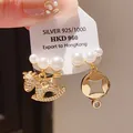 Detail of asymmetric pearl earrings with crystal-studded horse and geometric charms - Gold White Pearl Pendant (59#)