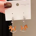 Detailed close-up of orange enamel rocking horse earrings on 316L stainless steel display card - Silver Orange Glazed Horse (37#)
