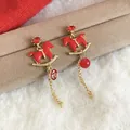 Festive red enamel rocking horse drop earrings with gold chain and lucky charm tag. - 55# Silver Pin - Gold Red