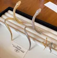 Golden and silver twisted snake-shaped open bracelet and ring jewelry set with textured scales - Bracelet and Ring Set / Gold