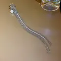 Detailed view of elegant silver tassel ear cuff featuring a pearl and sparkling rhinestones. - Ear Cuff-Single Left Ear (HE15208) / Silver