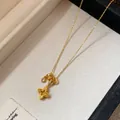 Detail of gold-plated flower pendant necklace with zircon stones in a jewelry box - Gold