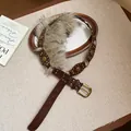 Detailed macro view of vintage leather rivet belt with chic light brown faux fur trim - Belt - Coffee