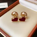 Close-up detail of elegant red velvet heart earrings with gold beaded edges and pearl back. - Flocked Heart Style (HE29818) / Red
