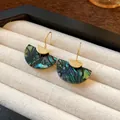 Close-up of vintage fan-shaped earrings with green marbled pattern in a display box - Fan Shaped Ear Hook / Gold-Green