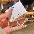 Close-up of luxury white enamel and gold-toned hoop earrings on a display card - White Enamel Gold Mix (1#) / White