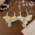 Detailed view of elegant vintage shell petal hoop earrings with pearls on wood tray - Pearl Ring Shell Tassel Style (3# Silver Post)