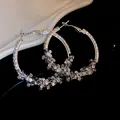 Elegant silver-tone hoop earrings with sparkling crystal clusters and silver needles. - Stacked Rhinestone Cluster Style (HE8275-18) / Silver