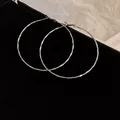 Large silver-colored hammered texture hoop earrings with a minimalist chic design - Wave Hammer Texture Style (HE8275-24) / Silver