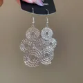 Elegant silver-toned hollow circular spiral earrings with a textured metallic luster finish - Spiral Hollow Disc (44#) / Silver