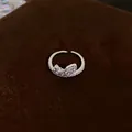 Detail view of a silver geometric open ring set with sparkling cubic zirconia stones - Geometric Plain Style