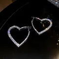 Elegant heart-shaped hoop earrings with sparkling rhinestones in a silver-tone finish - Heart Style / 925 Silver Needle / Silver