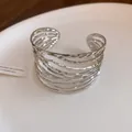 Detailed view of silver twisted metal open cuff bracelet with vintage feather texture - Twisted Openwork Style / Silver