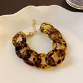 Close-up detail of a vintage leopard print resin chain necklace with gold clasp - Gold Bracelet - Leopard Coffee