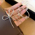Elegant silver bow earrings with a minimalist design for a sweet and sophisticated look - Large Bow Style / Silver