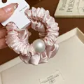 Close-up view of a pink satin pleated scrunchie featuring a large elegant pearl detail. - Pearl Decorated Style / Pink