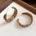 Close-up detail of stylish acetate C-shaped earrings with retro leopard print pattern - C-shape Style / Coffee Leopard