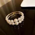 Elegant double-row white pearl open bangle with gold-tone finish and shiny zirconia - Artificial Pearl Open Cuff Bracelet / Gold