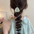 Detail view of a green rose hair clip and spiral hair tie on a bubble braid hairstyle. - Green Flower (8#)