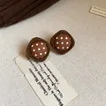 Close-up detail of vintage brown polka dot fabric stud earrings with a soft flocked border - Rhombus Polka Dot Style / Brown