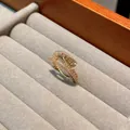 Close-up of a gold-plated zipper ring with pavé zircon stones in a velvet tray - Zipper Snap / Gold