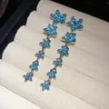 Close-up detail of elegant long tassel earrings featuring blue zircon flower patterns - Silver Post Flower Tassel Style (WE5166) / Blue