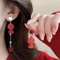 Close-up of festive red asymmetric earrings featuring cartoon snake charms and velvet balls. - Red Little Snake Style (4#) / Gold Red