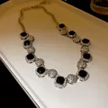 Macro detail of luxury geometric pavé necklace with black square stones and silver chain - Silver