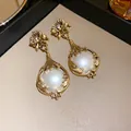 Macro detail view of vintage floral drop earrings with white pearls and gold-tone finish - Earrings (HN4775) / Silver Needle / Gold