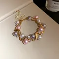 Close-up detail of vintage gold-toned bracelet with multi-colored pearls and crystals - Bracelet / 1 Piece / Gold White Pink Gray