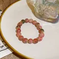 Close-up of New Chinese Style colorful cracked pattern glass bead bracelet on a plate - Style 52 Red Green (Crackle Glass)
