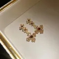 Macro detail of vintage gold floral earrings with shimmering rhinestones and amber gems - Earrings (Flower Style-Silver Post) / Gold Brown