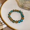 Detailed view of a hand-beaded elastic bracelet with blue and orange crackle beads - Style 62 Orange Blue (Crackle Glass)