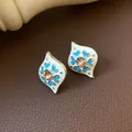 Vintage style enamel stud earrings with champagne diamond and blue heart pattern - Leaf Shaped Blue Heart Earrings (Silver Earring Post) / Gold-Blue