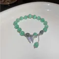 Elegant light green cat's eye beaded bracelet with a sparkling crystal butterfly charm detail - Green Butterfly Style (HB1324)