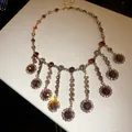 Elegant vintage style necklace with amber colored crystals and gold-tone floral tassel charms - Flower Tassel Crystal Necklace / Gold Brown