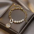 Elegant gold bracelet featuring white pearls, a shell smiley pendant, and a number 5 charm - Color Block Pearl Smiley Face Bracelet / Spliced Freshwater Irregular Pearl