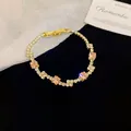 Elegant gold-plated tennis bracelet featuring pink square crystals and shimmering clear stones - Gold Tennis Bracelet / Paved Gold