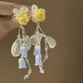 Detail shot of fairy-style chiffon lily of the valley tassel earrings with glass beads - Mori Style Beaded Leaf Blue Tassel (16# Silver Earring Post - White-Yellow)