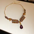 Elegant vintage gold necklace featuring amber crystals and a large red teardrop pendant - Necklace (23#) / Gold Brown