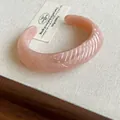 Minimalist peach pink translucent resin cuff bracelet with wavy leaf texture detail - Style 31