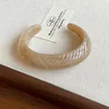 Elegant marbled beige resin open cuff bracelet with unique geometric textured pattern - Style 33