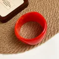 Vibrant orange wide resin bangle with smooth glossy finish displayed on a woven mat - Bright Orange Ring Style (47#) / Orange