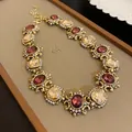Vintage style gold-tone necklace featuring purple and champagne gemstones with rhinestone accents - Necklace (48#) / Gold-Purple