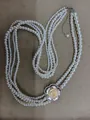 Elegant multi-strand pearl necklace featuring a sparkling rhinestone flower pendant design - Four Layered Style