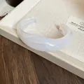 Wide acrylic cuff bracelet with white marble effect and irregular minimalist design. - White